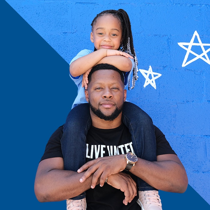 Daughter on shoulders of father Live United