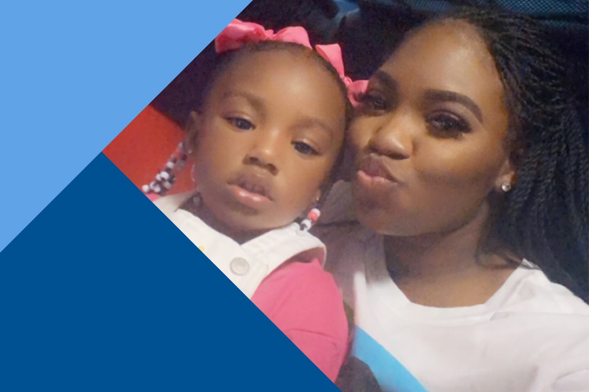 black mom and daughter smile for camera