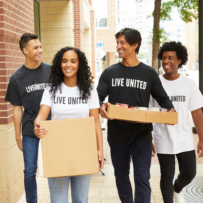 young volunteers take canned goods to destination